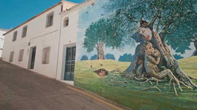 Captivating Olive Tree Mural Adorns a Sunny Village Wall in Peal de Becerro, Spain