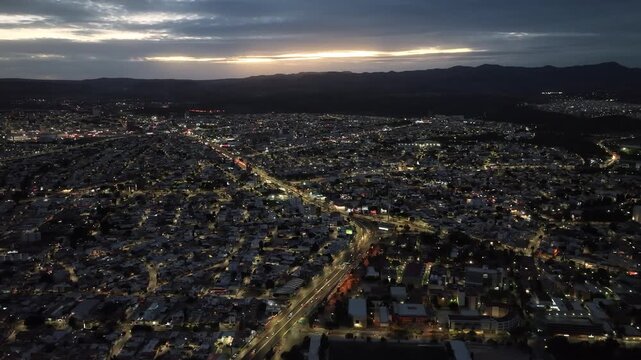 Aerial panoramic view of Salvador Nava avenue and Lomas area at dusk, city lights in San Luis Potosi, Mexico