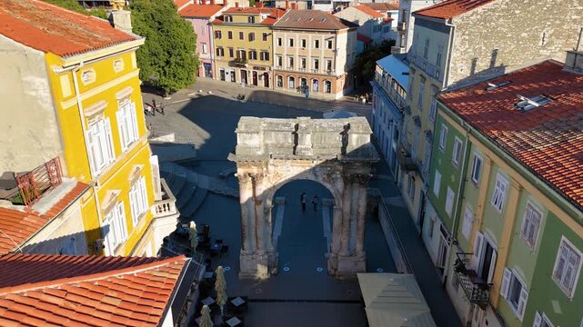 Aerial descending view of arch of the sergii in pula croatia