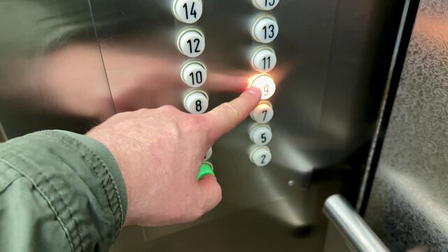 Close-up elevator button panel finger press, commuter man in green jacket selects floor on stainless steel control panel