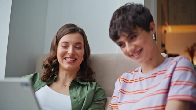 Joyful besties finish videocall waving hands in tablet closeup. Smiling women 