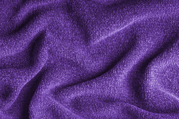 Closeup, macro of purple microfiber fabric texture with soft folds and drapery. Plush, fleece textile surface suitable for background, wallpaper and design use. Upholstery, decorative cloth © katyamaximenko