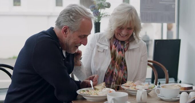 Lunch, cafe and happy senior couple eating together for bonding, quality time and conversation. Restaurant, marriage and mature man and woman laughing with food to relax, chat and date in coffee shop
