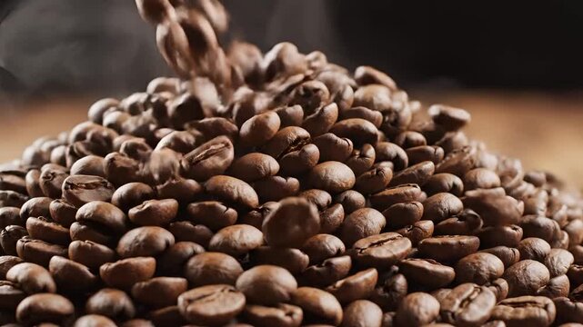 Closeup of Freshly Roasted Coffee Beans Pouring into a Pile.
