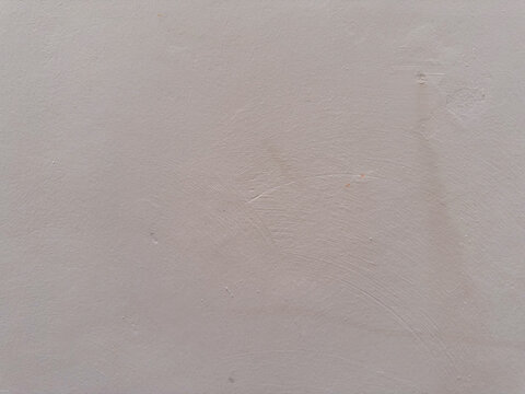 Expansive neutral wall plane presenting nuanced surface topography in a gentle, warm gray hue