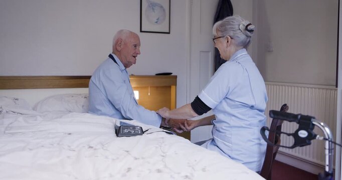 Senior man, rehab and pulse of medical caregiver checking blood pressure or sugar levels. Elderly male in checkup, visit or diabetic at home with woman nurse monitoring health and wellness in bedroom