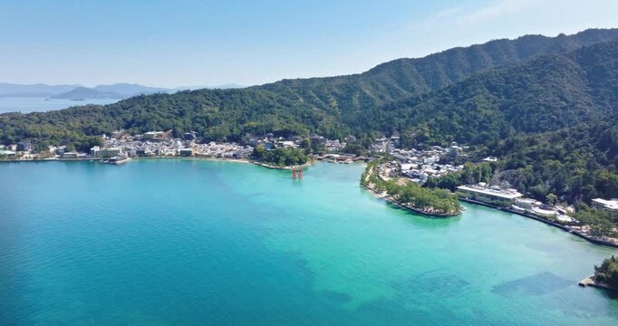 Scenic Aerial Drone View of Turquoise Water Bay and Coastal Town Nestled in Green Hills, Tropical Resort Village Harbor, Beautiful Ocean Sea Coast Landscape, Summer Travel Destination