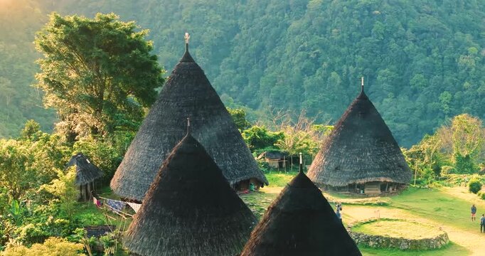 Authentic Aerial Drone View of Wae Rebo Traditional Village in Flores Indonesia, Cone Shaped Mbaru Niang Houses Hidden in Green Mountains, Cultural Heritage Site, Remote Travel Destination