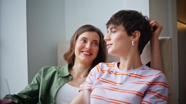 Happy bisexual women talking at relaxed atmosphere closeup. Smiling brunette