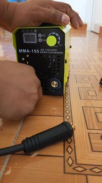 Unplugging Positive And Negative Twist Lock Cables From Mini Welder