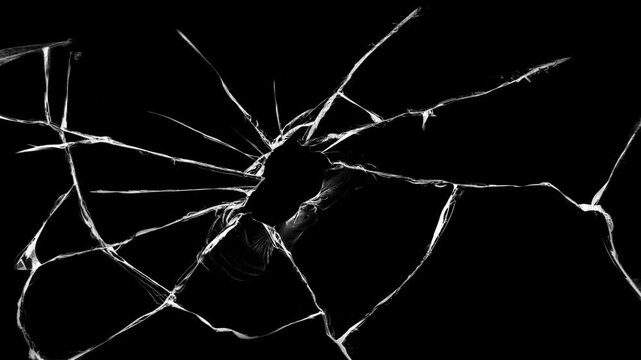 Broken cracks glass fracture effect texture abstract black background. Dynamic cracked screen overlay with sharp glass fractures in a dark background.
Dynamic explosion of a glass shattering.