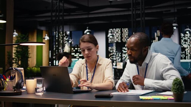 Diverse business professionals team working together in office space, collaborating on project assignments. Staff developing strategic agenda to drive company growth and success.