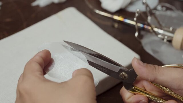Cutting sheer fabric petal pattern for handmade bridal flower and couture decoration