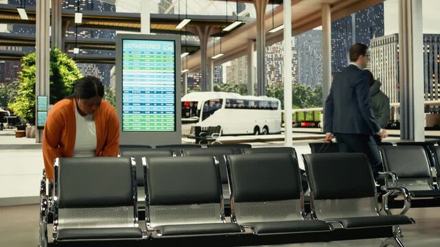 Busy bus station with travelers waiting for express and sleeper bus routes. Multicultural passengers with baggage sitting in waiting area before long-distance interstate journey.