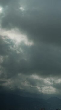 Timelapse of clouds sky are scudding over mountains vertical video. Storm warning, climate change, environmental protection. Problem of urban air pollution