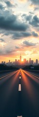 Fototapeta premium Wide road stretching toward the city skyline at dawn, under a cloudy sky, road, tranquil