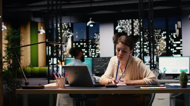 Diverse man and women working together on project in corporate space, collaborating on business intel data research. Coworkers brainstorming ideas, managing assignments for strategic goals.