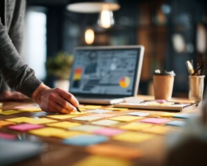 Fototapeta premium Sticky note planning laptop hand desk office workspace business strategy project startup founder at desk mapping quarterly goals with sticky note