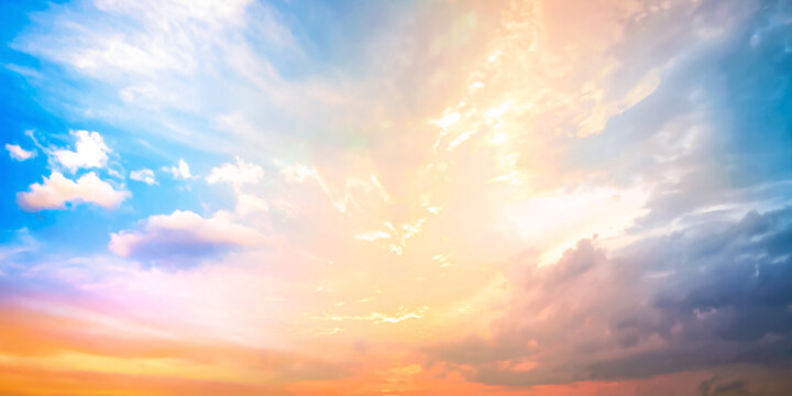 Beautiful bright golden sunset sky background with vibrant blue and dramatic purple pastel clouds for inspirational nature wallpaper panorama