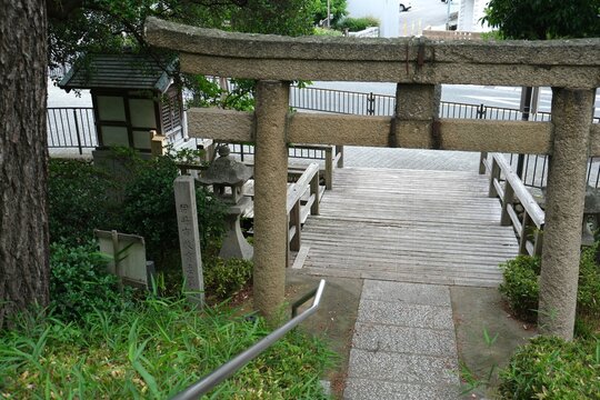 Stone torii gate and a wooden bridge at a Japanese shrine