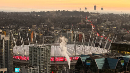 Fototapeta premium Vancouver , Canada - January 2026: BC Place Stadium aerial view at dusk with Vancouver cityscape