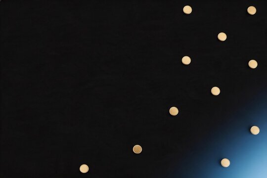 Scattered gold coins on dark surface