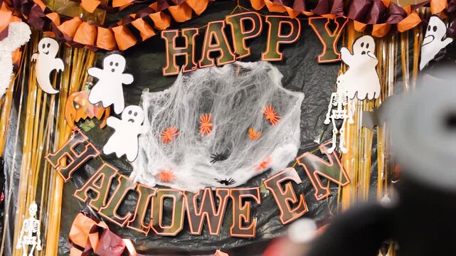 View of a sign decorated with colorful objects for a happy Halloween night in Neiva, Huila, Colombia. Concept of objects and celebration