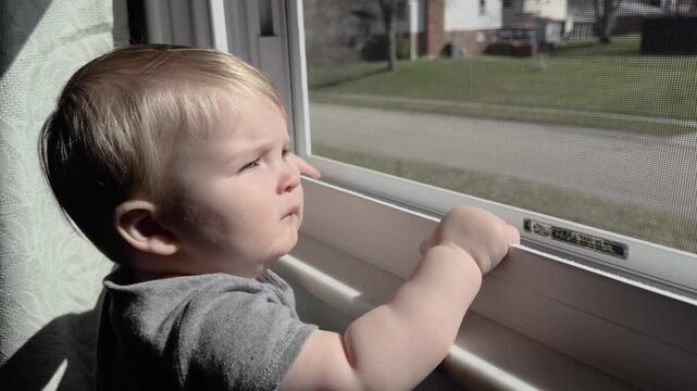 Young boy looking at car drive by in neighborhood 4k