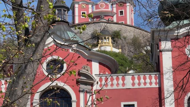Stunning red and white baroque architecture of the Banska Stiavnica Calvary in Slovakia. A slow vertical pan revealing the historic religious complex