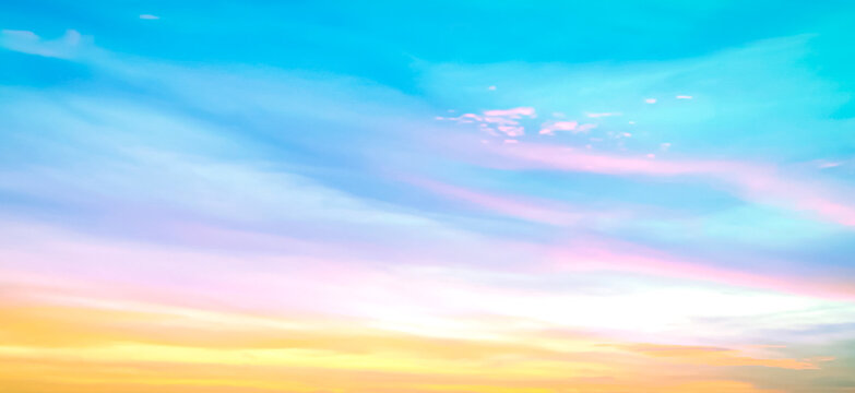Beautiful vibrant cyan blue sky background with colorful pastel pink and golden orange clouds at sunset for inspirational nature wallpaper panorama