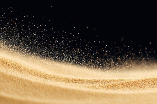 Close-up of fine golden sand creating a mesmerizing wave pattern.