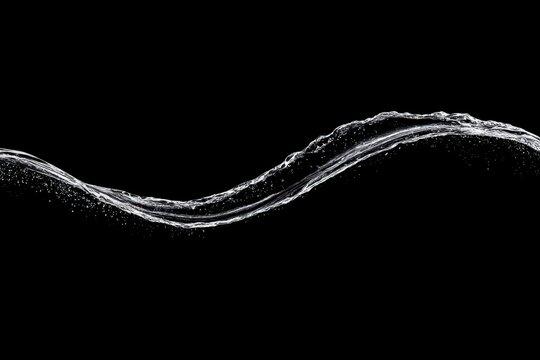 Elegant water wave gracefully flowing against a black background.