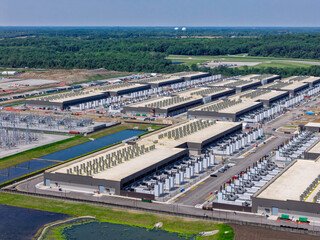 Aerial view of the construction of data center complex, large AI center structure surrounded by cooling and power systems