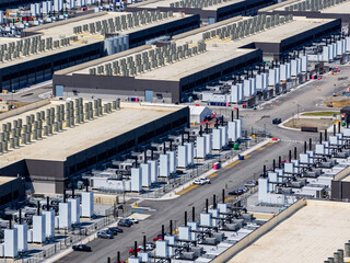 Fototapeta na wymiar Aerial view of the data center buildings, large AI center structure surrounded by cooling and power systems