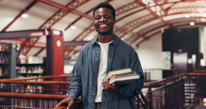 College, face and man with books in library for thesis research, test preparation or study material. Education, black person and happy with textbooks at university for learning or academic resources