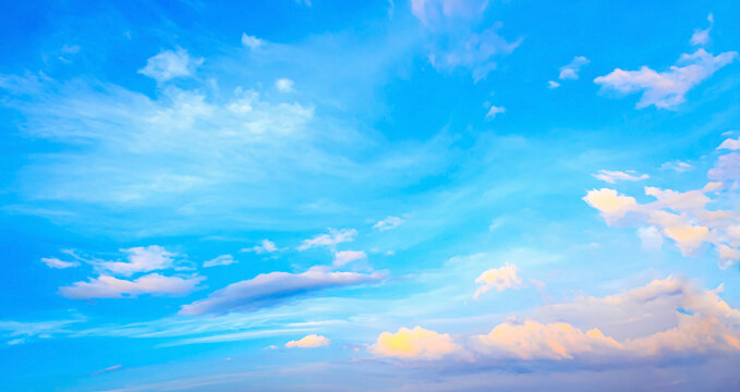 Beautiful vibrant cyan blue sky background with colorful pastel pink and golden orange clouds at sunset for inspirational nature wallpaper panorama