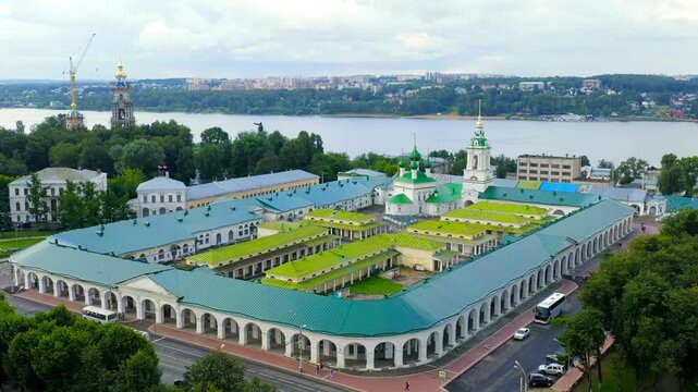 Kostroma, Russia. Church of the Savior in the Rows, five green domes and classical bell tower integrated into historic Neoclassical trading arcades, Drone footage over the Volga River. Drone footage