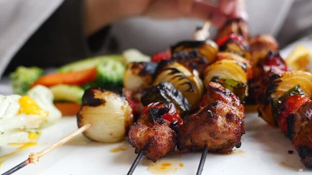 Grilling skewers with meat and vegetables at outdoor cookout