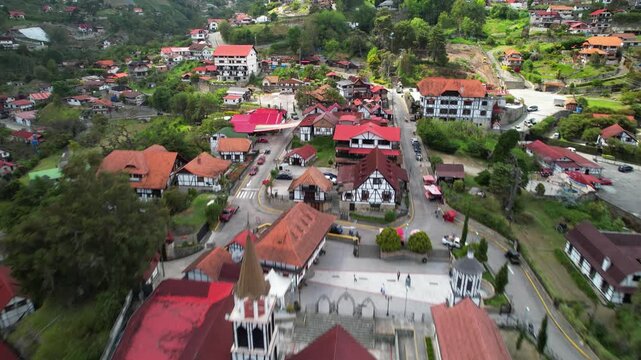 Aerial over Colonia Tovar red roofs and historic church landmark in mountain village, Venezuela