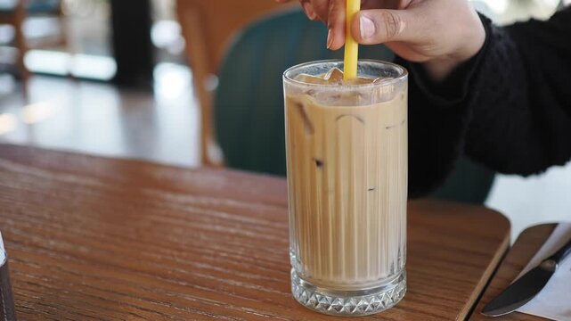 Enjoying iced coffee at a cafe during the afternoon
