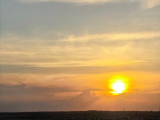 Obraz premium Golden Sunset Glowing Above Rural Horizon And Clouds