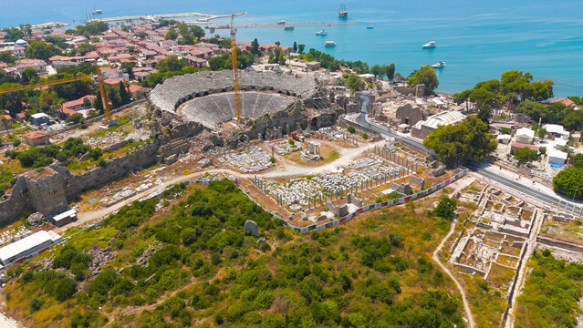 Side, Manavgat, Turkey. Ancient Roman amphitheater, Monumental Gates of Side, Side Museum in Roman baths, Temple of Tyche in ancient city on summer day. Aerial View