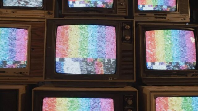 Vintage TVs Stacked Displaying Static Rainbow Color Bars