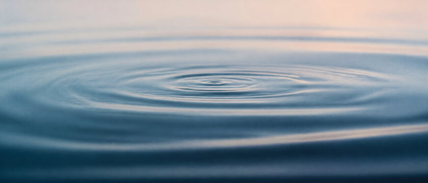 Serene Water Ripples Creating Patterns on Calm Surface at Sunrise