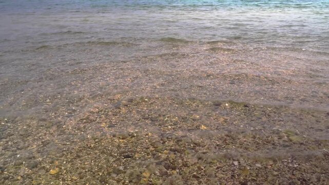 Close-up of crystal clear shallow water rippling gently over rocks at low tide on Higawa Beach, Yonaguni Island, Japan