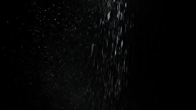 White powder falling down against a black background in slow motion for food concept