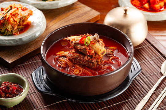 Spicy Korean Beef Rib Soup Galbitang in Clay Pot with Kimchi and Side Dishes