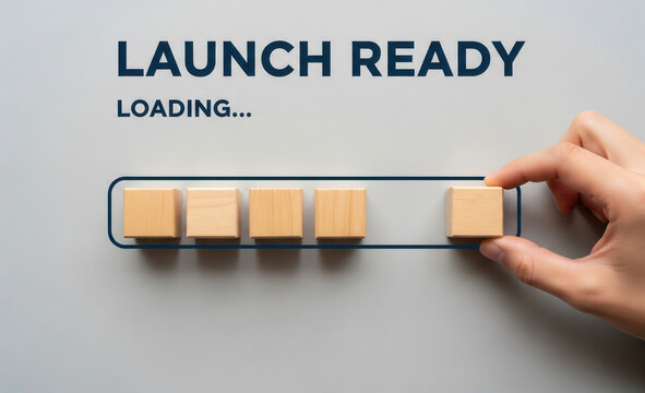 Launch ready loading concept with hand completing progress bar using wooden blocks