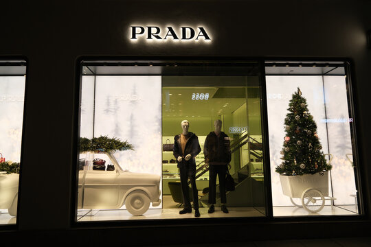 Oslo, Norway-Nov.25th 2025: Prada storefront window display featuring a festive theme with a Christmas tree