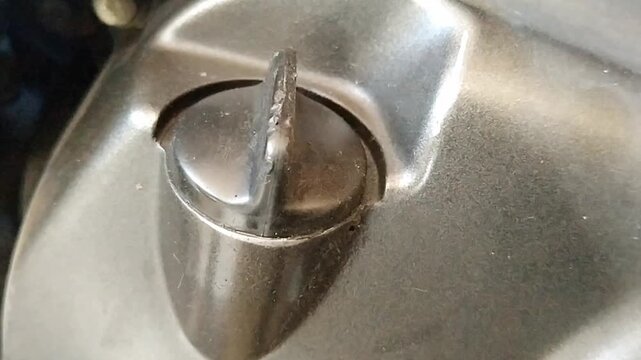Close up of prominent vertical rotary knob design for engine oil filler cap on machine
